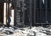 Arkansas State Police arson investigator Shannon Shepherd and two others looks over the remains of Loretta Marie Slaughter-Shirah's home in June 2008. Before her rent house burned down, a cross was burned in the yard. The men indicted in the cross-burning case were not accused in the house burning.