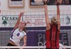 Fayetteville junior Morgan Cosby (8) spikes the ball past Russellville senior Teryn Laseter (1) in the second set Tuesday at Fayetteville High. The Lady Bulldogs won 3-1. 