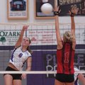 Fayetteville junior Morgan Cosby (8) spikes the ball past Russellville senior Teryn Laseter (1) in t...