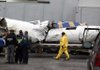 Plane wreckage is loaded onto a flatbed trailer for removal where Continental Flight 3407 crashed into a home in Clarence, N.Y., on Feb. 18. The crash publicized the long hours, low pay and long-distance commutes of regional airline pilots.