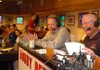 Arkansas head coach Bobby Petrino, left, talks during his radio show with host Chuck Barrett Wednesday at the Catfish Hole in Fayetteville. 