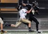 Bentonville Black's Trey Perkins delivered a stiffarm while being tackled by Bentonville Gold's Chris Mizelle during Thursday night's game at Tiger Stadium. 