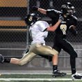 Bentonville Black's Trey Perkins delivered a stiffarm while being tackled by Bentonville Gold's Chri...