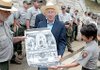 National Park Service employee Leonard Lawson presents U.S. Interior Secretary Ken Salazar with a poster Thursday at Hot Springs National Park. Josie Fernandez, park superintendent, looks on.