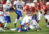 Ramay Junior High tailback Brice Gahagans (28) is tackled by Woodland Junior High free safety Ryan Starr during the first half of play Thursday at Harmon Field. 