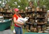 Lashay Swem unpacks her crafts Friday as she gets ready for Prairie Grove's Clothesline Fair at the battlefield park. Swem's stand, called Something Old Something New, features a variety of items with her designs painted on them. 
