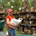 Lashay Swem unpacks her crafts Friday as she gets ready for Prairie Grove's Clothesline Fair at the ...