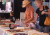 Tonia Squires, left, looks at some jewelry at Evelyn and Bill's Western Wear and More display with her daughter, Wren Squires, 2, and mother-in-law, Reba Squires, Friday at the Washington County Fair in Fayetteville. 