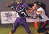 Elkins quarterback Robert Teague (3) gets rid of the ball before being tackled by a Pea Ridge defensive player during the first half of Friday's game at Elkins. 