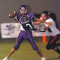 Elkins quarterback Robert Teague (3) gets rid of the ball before being tackled by a Pea Ridge defens...
