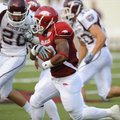 Arkansas sophomore Dennis Johnson returns the opening kickoff for a touchdown during the Hogs' 48-10...