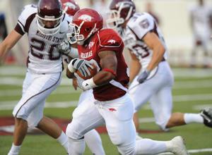 Arkansas sophomore Dennis Johnson returns the opening kickoff for a touchdown during the Hogs' 48-10 win Saturday over Missouri State at War Memorial Stadium in Little Rock.