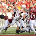 Missouri State junior quarterback Cody Kirby (13) is hit by Arkansas sophomore defensive end Jake Be...