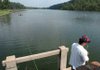Angel Arredondo fishes on Monday at Lake Wedington while families celebrate Labor Day at the lake, which reopened to the public last week. The lake and its recreation areas have been closed since January due to the devastation caused by the ice storm.