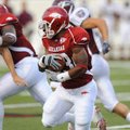 Arkansas sophomore Dennis Johnson returns the opening kickoff for a touchdown during the Hogs' game ...