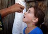 A Pakistani volunteer administers polio vaccine drops Tuesday to a girl in Mingora, Pakistan.