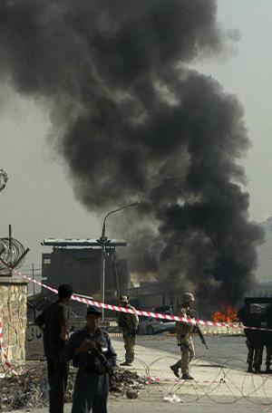 Soldiers secure a military airport Tuesday in Kabul, Afghanistan, after a car bomb exploded in an apparent attack on an international convoy. The Taliban claimed responsibility for the blast.