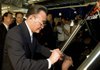 Chairman Wu Bangguo of China's Standing Committee of the National People's Congress signs a solar panel Monday in Phoenix made by First Solar Inc., based in neighboring Tempe, Ariz.
