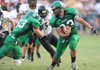 Greenland senior running back Jeremy Huber (33) carries the ball through the West Fork defense during the first quarter of play Friday in Greenland.
