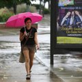 Rachel Keng of Fayetteville walks down Dickson St. past the Walton Arts Center in a light rain Wedne...