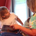 Sage Collette, 4, of Fayetteville passes a rainy day reading with her grandmother, Barbara Hogue of ...