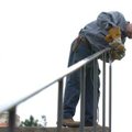 Charlie Wallace, a welder with the University of Arkansas, works on grinding his welds smooth Wednes...