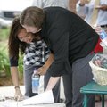 Ha Vu (left) and Whitney Sutherland both with S.C. Johnson & Son, Inc. look over the silent auction ...