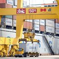 Containers for COSCO, the China Ocean Shipping (Group) Company, are loaded Friday onto a ship in the...