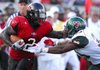 Arkansas State's Reggie Arnold , left, fights off a tackle attempt by Mississippi Valley State's Armon Williams during the first half of an NCAA college football game in Jonesboro on Saturday, Sept. 5, 2009.