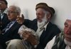 The father of Sultan Munadi cries as he offers a prayer for his son, an Afghan translator and journalist who was killed during an operation by British forces to rescue a British-Irish journalist. Afghan journalists criticized the mission on Thursday.