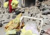  An Iraqi woman carries her belongings out of the ruins of her home after a suicide truck bombing Thursday in the Shiite Kurdish village of Wardek, about 35 miles southeast of Mosul.