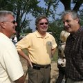 Larry Williams, one of the partners with Macadoodles (center) TLJ Properties, talks with contractor ...