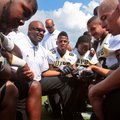 UAPB football coach Monte Coleman, second from left, addresses his team during a media day workout i...