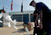 Gary Wellesley of Rogers Veterans of Foreign Wars Post 3031 released a basket of white doves during a 9/11 memorial ceremony at Veterans Park in Rogers on Friday morning.