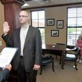 <b>Swearing in</b>
Bentonville Mayor Bob McCaslin, left, swore in Ryan Parks as the replacement ald...