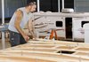 Troy Urban works on the frame for a travel trailer at Heritage One RV Inc. in Nappanee, Ind.
