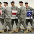 A carry team lowers the transfer case containing the remains of Army First Lt. Tyler E. Parten of Ar...