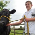 Joshua Lockhart, 13, of Bentonville is shown with his cow, Leah, on his family farm in Bentonville o...
