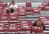 Nathan Jones, 16, from top, Zane Harrod, 15, both members of the
Fayetteville High School band and Joseph Richardson, 14, member
of the Woodland band, install seats Saturday at Razorback Stadium in
Fayetteville. Dozens of volunteers with the band and band boosters
installed the seats to raise money for band trips.