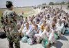 Afghan army recruits receive their first training instructions from an officer as they arrive at the Kabul Military Training Center in Kabul, Afghanistan, in July.