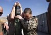 German International Security Assistance Force soldiers prepare ammunition Sunday before a patrol in Feyzabad, Afghanistan.