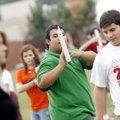 Carrying a notebook in place of his trumpet, Springdale High School sophomore Gary Sanchez (center),...