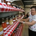 Doris Briley of Rogers puts entries to be judged on the shelves at the Adult Food Preservation exhib...