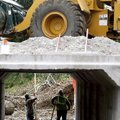 Eric Blumenthal (left) and David Sbanotto (cq) work with others with Crowder Construction Monday to ...