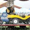An unidentified carnival worker set up a Midway ride as a steady rain came down at the Benton County...