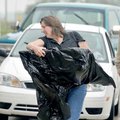 Carolyn Benham of Rogers hurried inside the Crafts Building with her artwork covered in plastic for ...