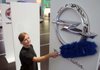 A worker cleans an Opel logo before the opening of the Frankfurt Motor Show in Frankfurt, Germany, on Monday.