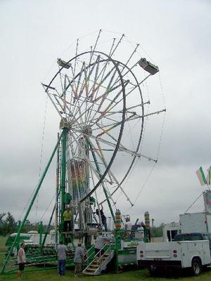 Employees of Archway Amusements erecting the ferris wheel on Monday from the late Michael Jackson's Neverland at the Baxter County Fairgrounds in Mountain Home. The fair opens Tuesday evening and runs through Saturday.