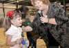 Hailey Harris, 4, of Gravette received the Best of Show ribbon from judge Annette Maze in the Junior Doe Open Class for the goat Monkeyface at the Benton County Fair on Tuesday.