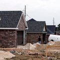 A worker stands near houses being built in July on Gunnison Avenue in the Parker Place subdivision i...